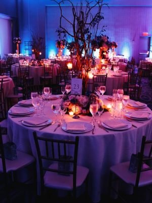 decorated-wedding-hall-with-candles-round-tables-centerpieces