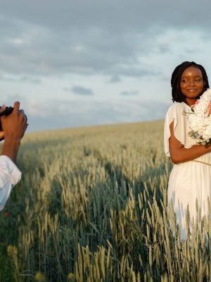 happy-couple-with-camera-at-summer-field-2024-12-06-20-53-37-utc
